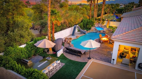 Elevated shot showcasing the expansive outdoor area with a pool, and lounge seating.