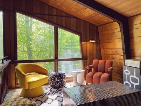 Loft lounge overlooking the trees and the living room below.