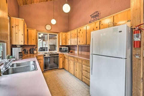 Fully equipped kitchen with gas range, ample cabinetry and natural light—prepare group meals with ease.