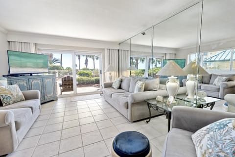 Relax in your elegant living room where coastal blues meet sophisticated comfort, with stunning views creating the perfect vacation backdrop.