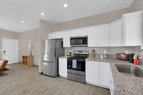 Nice clean appliances make this kitchen nice to cook in.