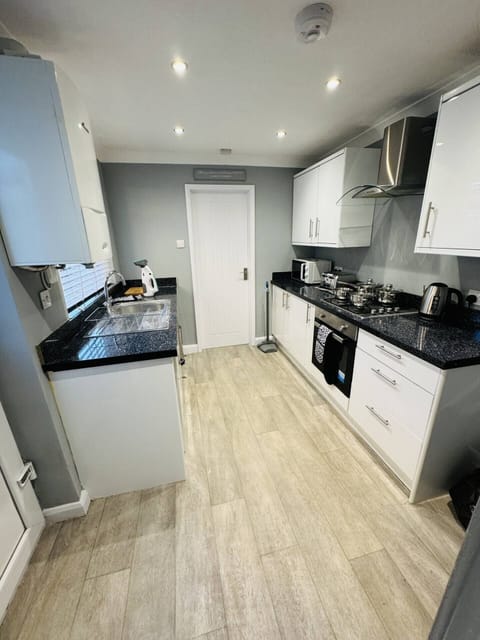 Modern fully equipped kitchen with high-end appliances, ample counter space, and everything you need for self-catering