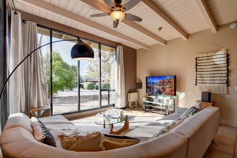 Main House Living Room - Spacious Living Room with Cozy Couch, Smart TV, and Large Window