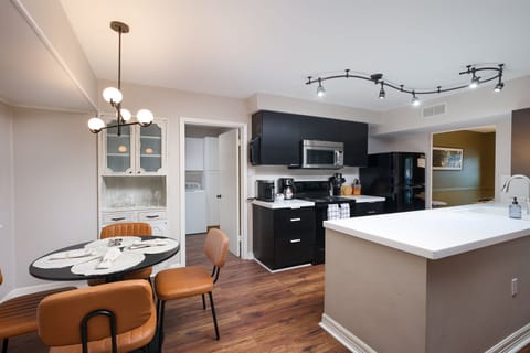 A cozy dining setup for four, conveniently located beside the kitchen—perfect for intimate meals or casual gatherings.