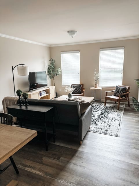 Living Room w/ Couch Bed, 55" Roku Smart TV, and 2 Vegan Leather Chairs