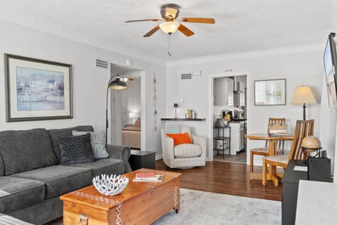 Family room -hardwood floor with large sectional, swivel chair, & small table