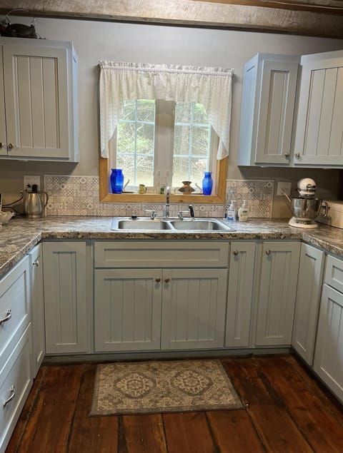 Full kitchen with Amish built cupboards, cooking, serving and dining dishes. 
