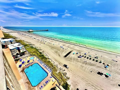 This shot was taken from the oceanfront bedroom balcony! Facing northeast, where you’ll see gorgeous sunrises. That’s the Maisons Sur Mer pool, the Apache Pier and the beautiful Grand Strand Beach!