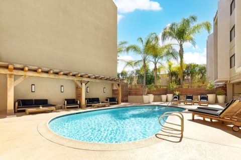Stretch out under palm trees beside the bright, inviting pool.
