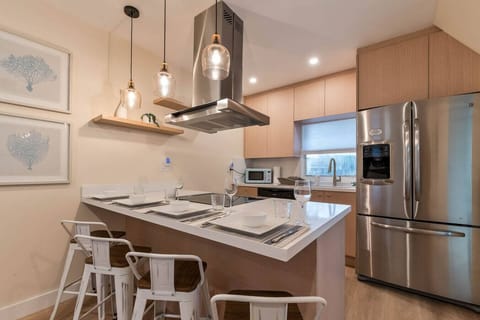Modern kitchen with stainless-steel appliances, island seating, and everything you need to cook & dine.