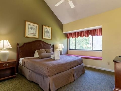 Unwind in a serene king bedroom with soft natural light.