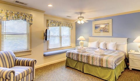Unwind in a sunlit king bedroom with plush linens.