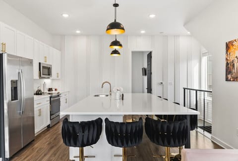 Open floor plan from the kitchen to living room, equipped with comfortable furnishings, plenty of natural light and all the kitchen essentials you would need. Plenty of seating for dining at our huge kitchen island.