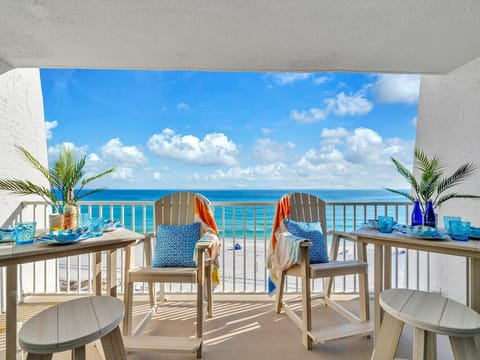 Step onto your private balcony where turquoise waters stretch endlessly before you, with tropical breezes and beach-inspired decor creating the perfect oceanfront escape.