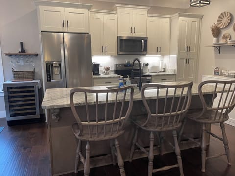 Kitchen with dishwasher and wine refrigerator. Kids & babies dishes and utensils