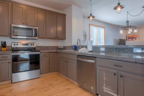 The fully equipped kitchen has ample counter space for preparing meals.
