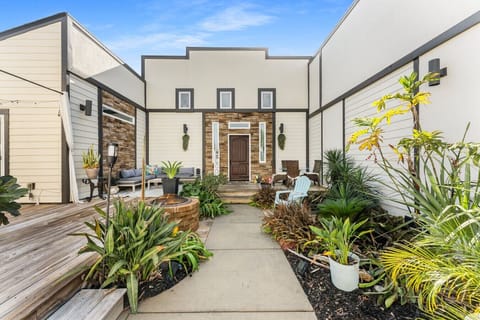 Beautifully landscaped area that is shared with seating at entrance of condo