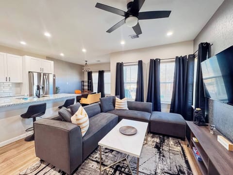 Comfortable sectional coach with 65" TV with work desk with nice kitchen
