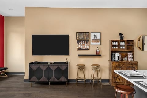 Relax in a stylish lounge featuring a sleek entertainment setup, cozy bar area, and fully stocked coffee station. Perfect for unwinding with a drink or movie night in a modern, inviting space.
