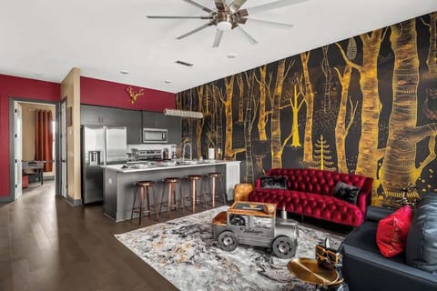 Step into a whimsical forest-themed retreat with bold décor, a striking gold tree mural, and vibrant velvet seating. Enjoy the full kitchen, foosball room, and unique vintage touches—perfect for an unforgettable Nashville stay!
