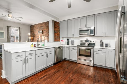 The kitchen is well-appointed with small appliances and stainless steel appliances. Keurig coffee-maker and pods are provided.