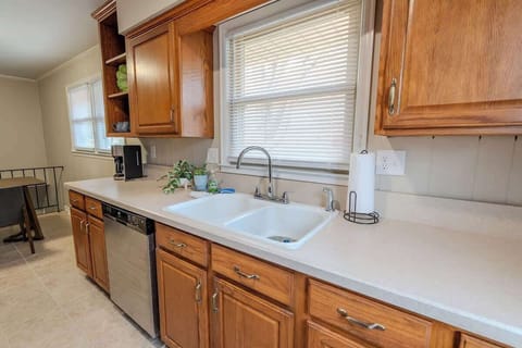 Kitchen with stove, sink and wooden cabinets