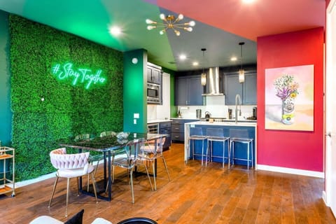 Modern Dining Area With Vibrant Decor And A Fully Equipped Kitchen