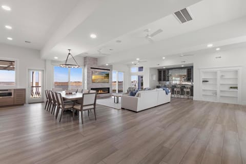 Main house living room and dining area opens up to outdoor dining and deck