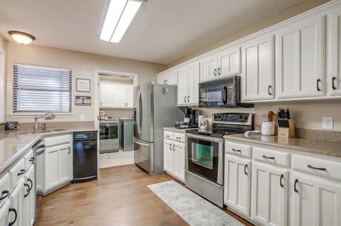 Bright and airy kitchen fully stocked with modern appliances, cookware, utensils, and a coffee bar to make your stay feel like home