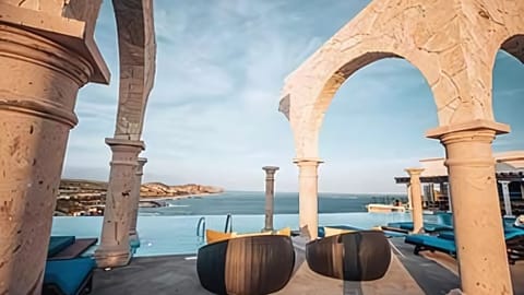 Vista Encantada infinity pool with arches and panoramic sea views.