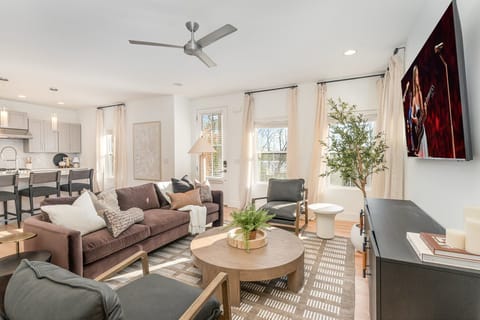 Relax in this stylish living room with comfortable seating, modern decor, and a flat-screen TV