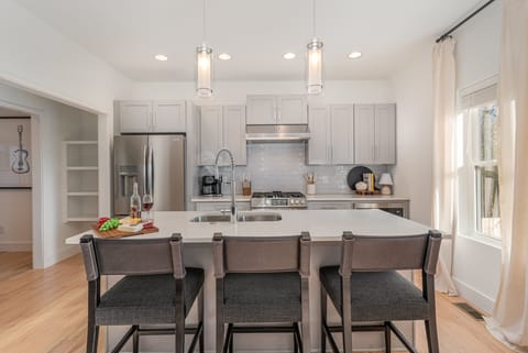 A sleek, modern kitchen equipped with everything you need to cook and gather, featuring contemporary appliances and ample counter space.