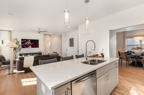 A sleek, modern kitchen equipped with everything you need to cook and gather, featuring contemporary appliances and ample counter space.