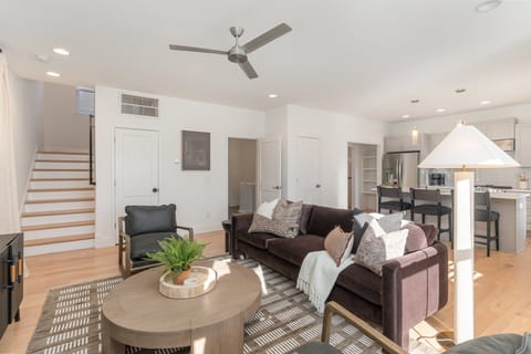 Relax in this stylish living room with comfortable seating, modern decor, and a flat-screen TV