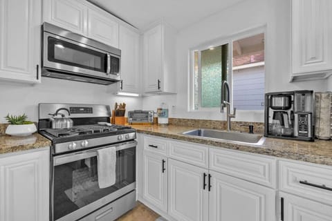 Fully stocked kitchen with blender, huge pots and coffee maker