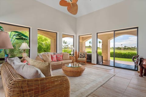 Tropical living room with 70" Smart TV, garden view and lanai access