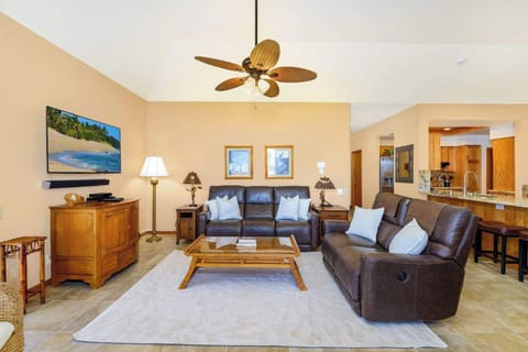 Living room with flat screen TV, comfortable seating and lanai access