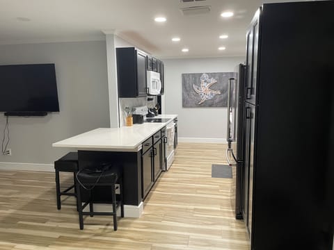 Kitchen with island with bar stools.