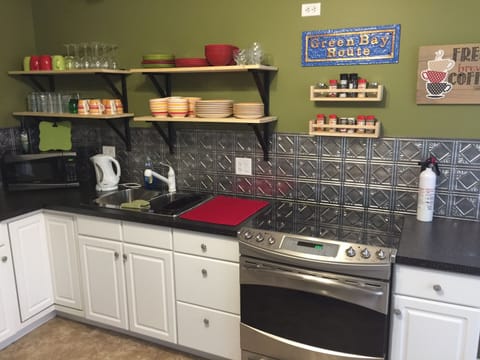 Kitchen, includes stove, fridge, microwave, air fryer, and coffee pot