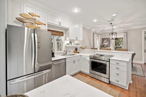 Kitchen: Stainless steel appliances, drip coffee maker, cooking utensils, tableware