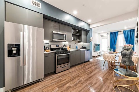 Bright, contemporary cooking space featuring integrated appliances and modern lighting, where elegance meets functionality.