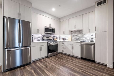Bright, fully equipped kitchen with a chef-ready layout and harmonious blend of texture, color, and light.