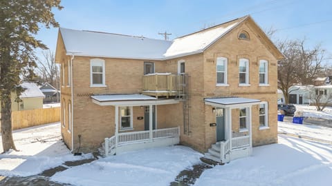 - Beautiful brick home surrounded by winter charm and peaceful neighborhood views - Welcoming entryway and cozy porch make your stay warm and inviting - Enjoy this charming home with nearby local attractions and easy access