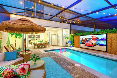 Private screen enclosed pool with optional pool heating, featuring a 120" move projector screen, sun loungers, pool games, accent lighting and outdoor dining space, professionally designed by Magic Interiors for the ultimate poolside oasis. 