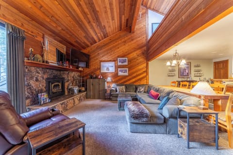 Open living room with vaulted ceilings and large sectional sofa.