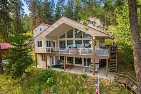 Lake life starts here with private waterfront access in peaceful Windy Bay. Image enhanced with AI to show what the home looks like during the summertime.