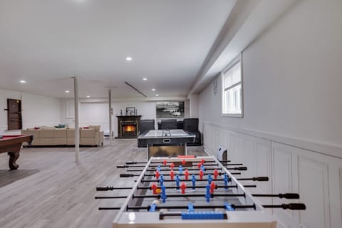 🎮 Ultimate Game Room Retreat — Enjoy foosball, ping-pong, cozy lounge seating, and a warm fireplace — the perfect hangout spot for family fun and rainy-day entertainment.