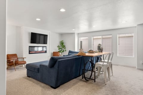 Relax in the comfortable living room with a large sectional al and smart TV