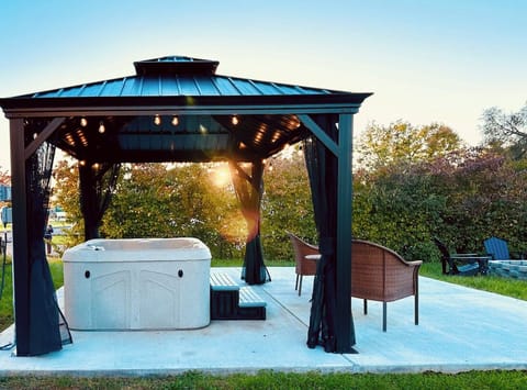 Backyard, pergola with outdoor seating & hot tub