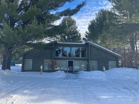 Condo Association clubhouse with outdoor pool behind for summer fun